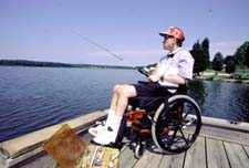 man in wheelchair fishing on accessible dock